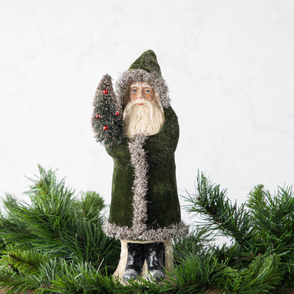 A 12&quot; Velvet Belsnickle figurine with a forest green velvet robe adorned with tinsel trimming and glitter, holding a tree.