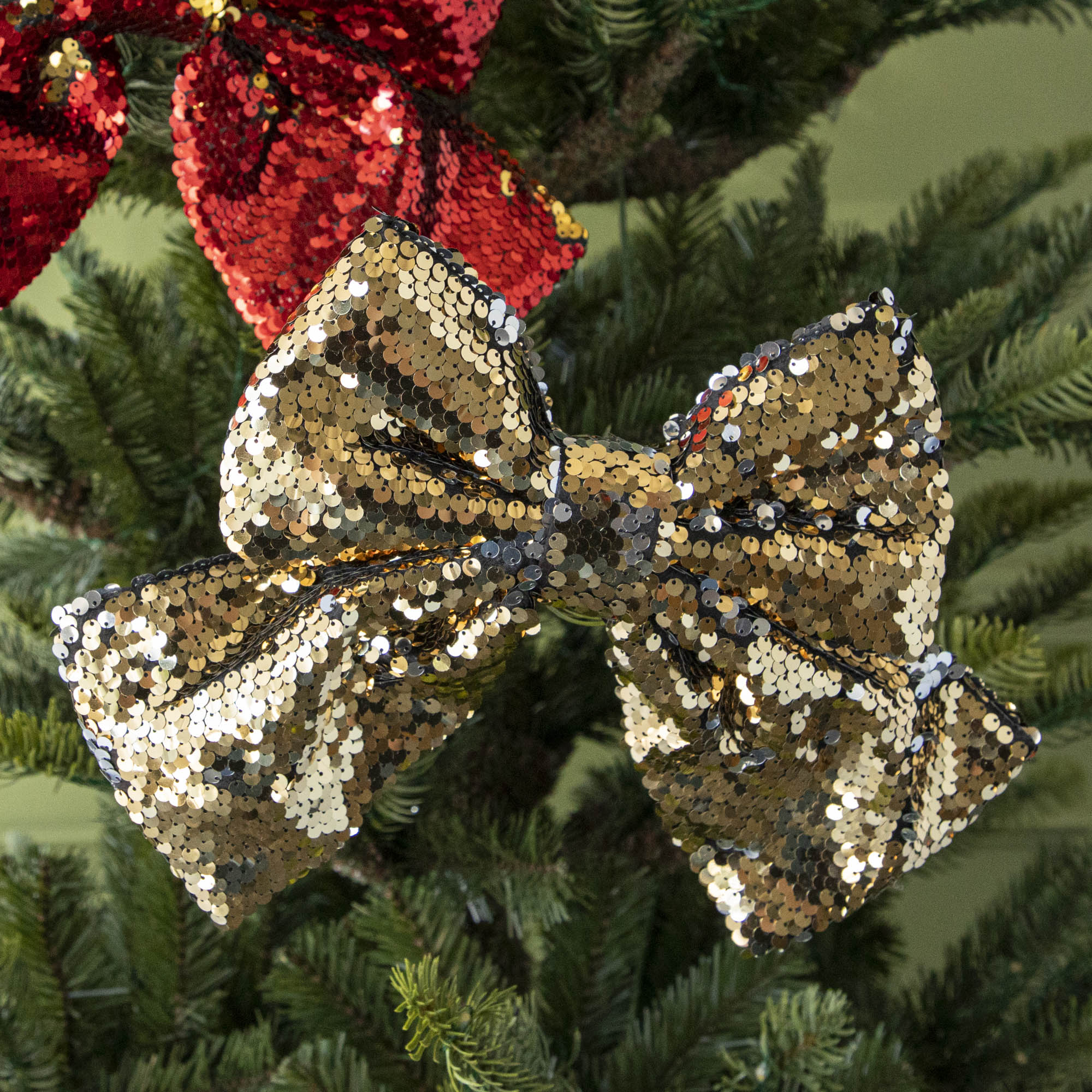 close up of gold sequin bow in tree