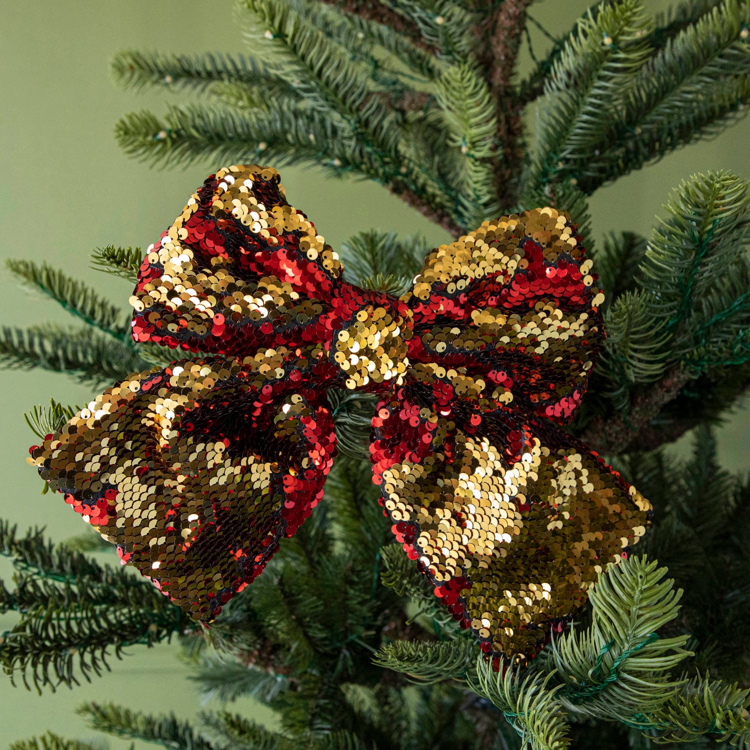 close up of gold sequin bow in tree