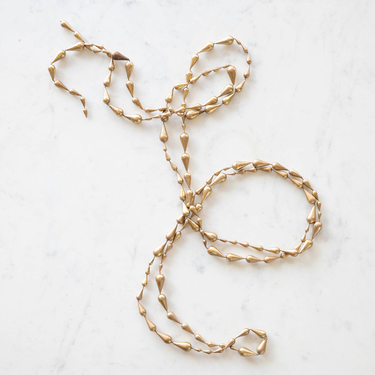 drop gold garland laying on a table 