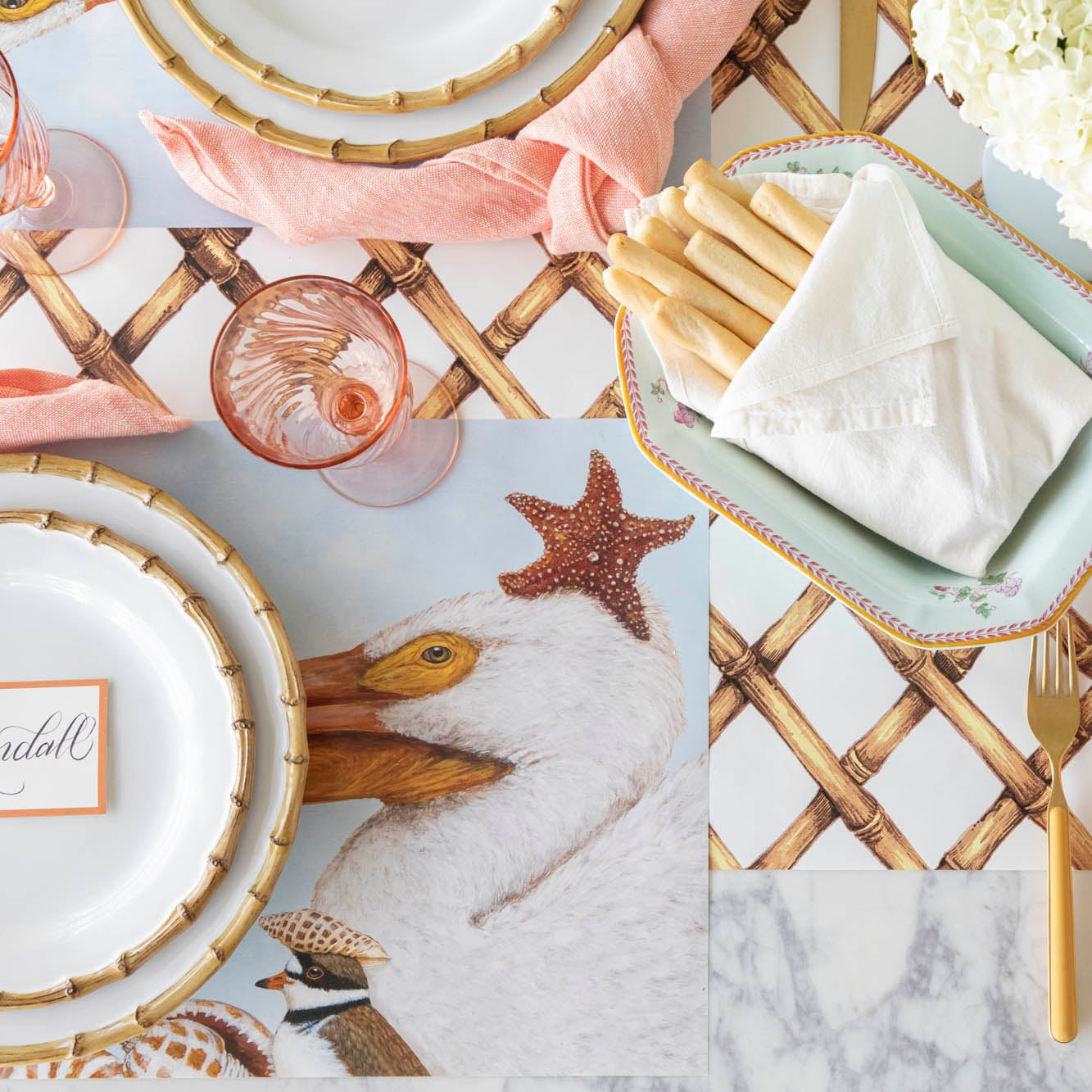 A coastal table setting with the Shorebirds Placemat under a place setting and Bamboo Lattice Runner underneath.