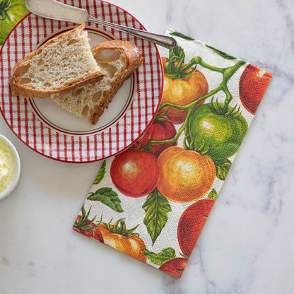 Tomato Guest Napkin under a plate of sliced bread.