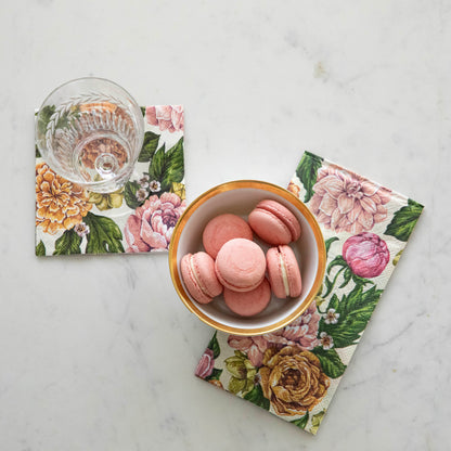 Garden Derby Guest Napkin under a bowl of macaroons and the Garden Derby Cocktail Napkin under an empty glass.