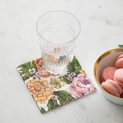 Garden Derby Cocktail Napkin under an empty glass next to a bowl of macaroons.