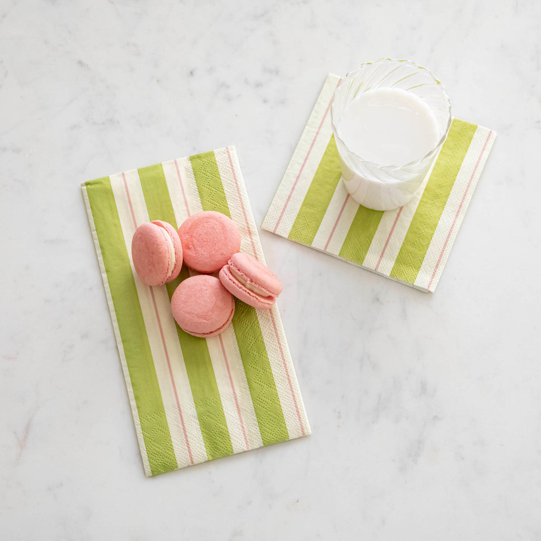 Green &amp; Pink Awning Stripe Napkins under macaroons and a glass of milk.