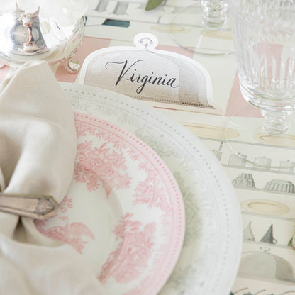 Serving Dome Place Card with &quot;Virginia&quot; on it, behind an elegant place setting for one.