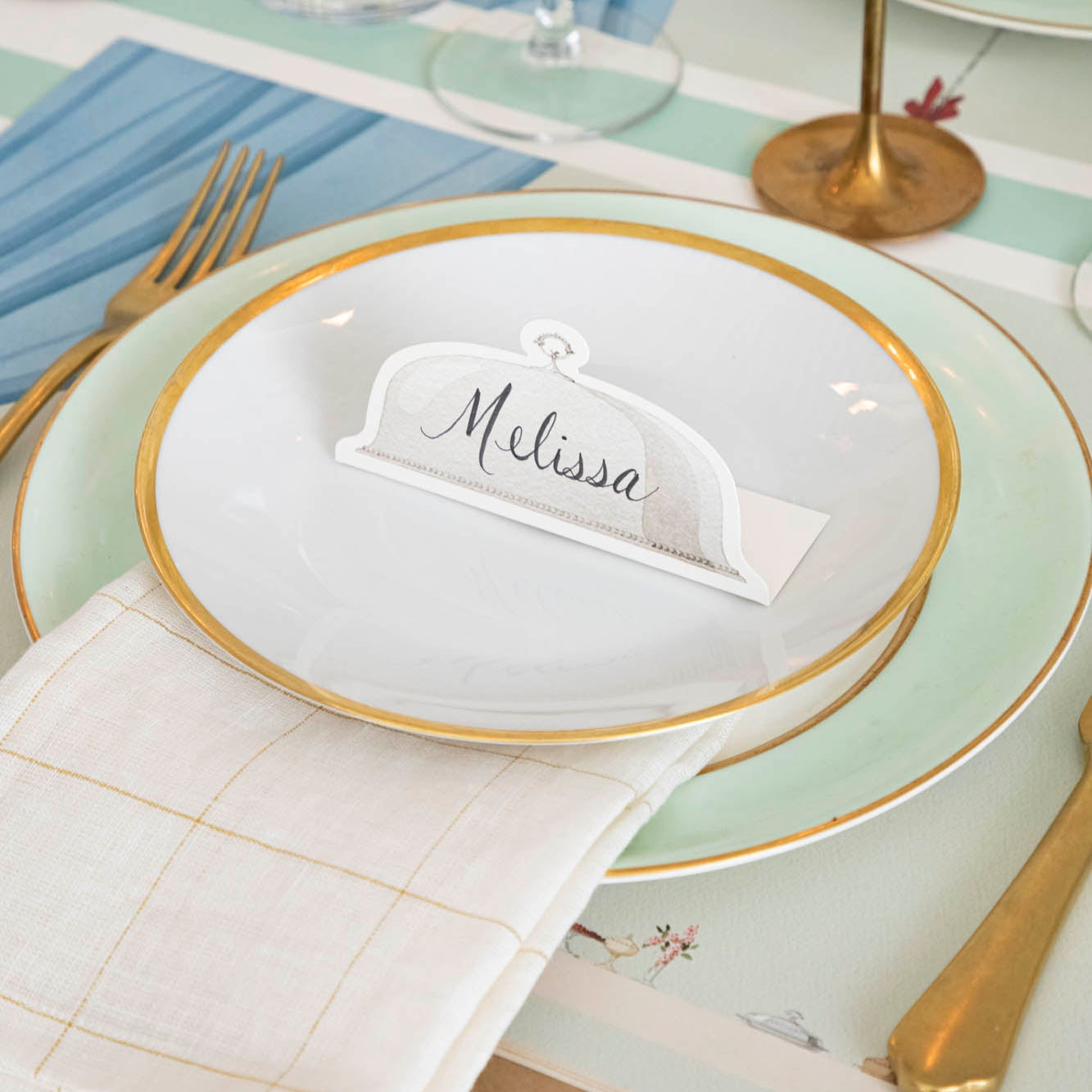 Serving Dome Place Card with &quot;Melissa&quot; written on it, on dinner plates.