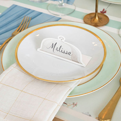 Serving Dome Place Card with &quot;Melissa&quot; written on it, on dinner plates.