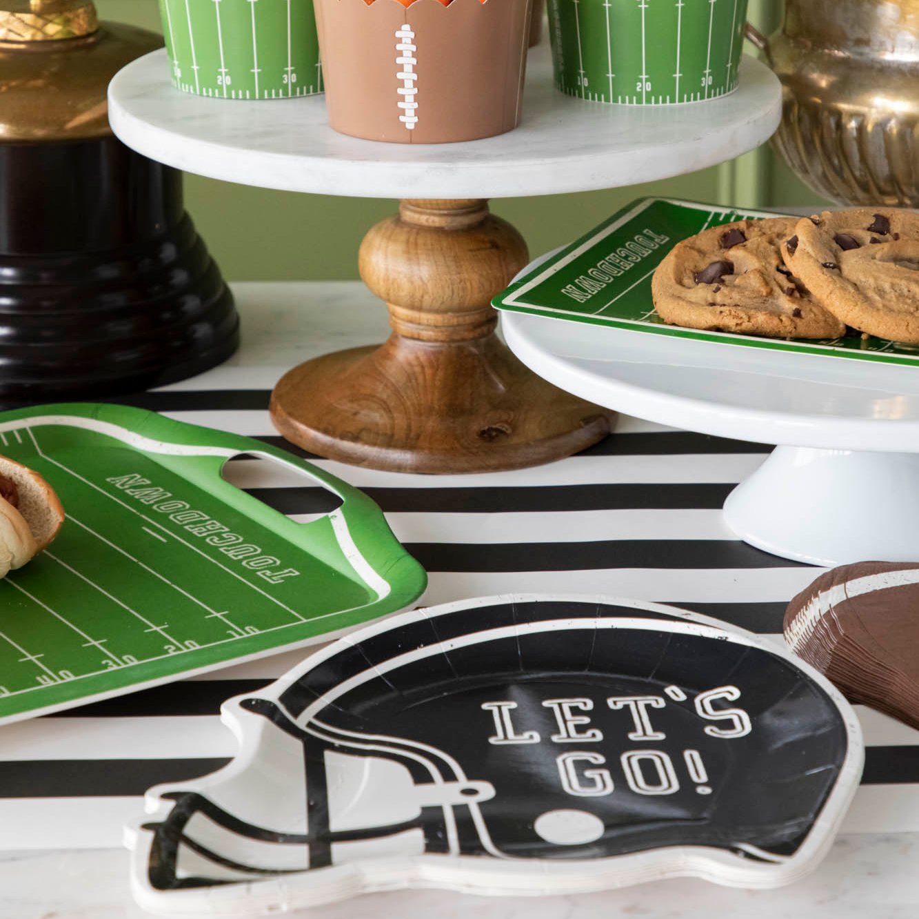 Football helmet paper plates on a football themed table setitng.