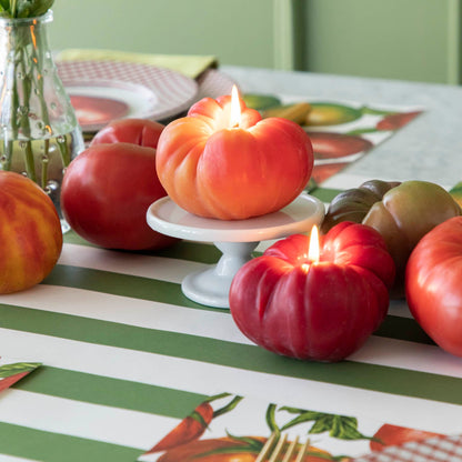 Tomato Candles lit in the center of a table.