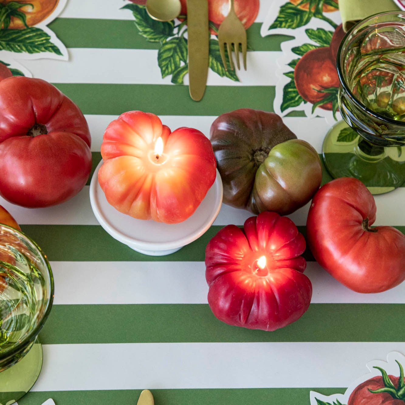 Tomato Candles lit in the center of a table.