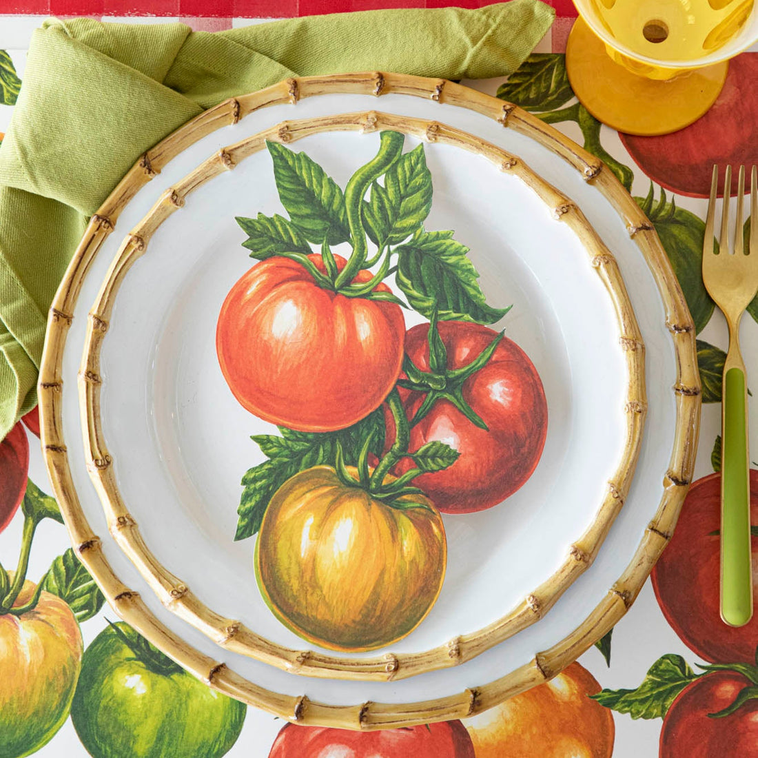 Tomato Table Accent resting on dinner plates, on a tomato themed place setting.