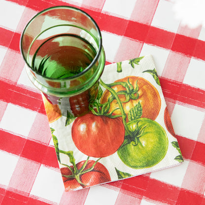 Tomato Cocktail Napkin under a glass and Red Painted Check Runner underneath.