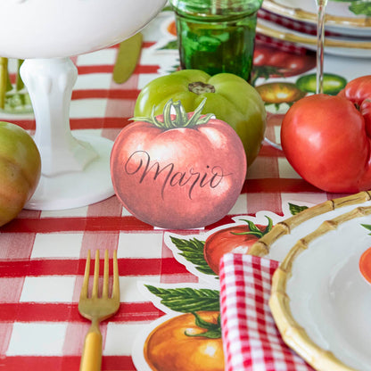 Tomato Place Card with &quot;Mario&quot; written on it, behind a place setting.