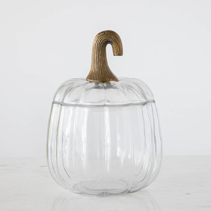 A medium Translucent Pumpkin Terrarium with an antique bronze stem lid on a marble table.