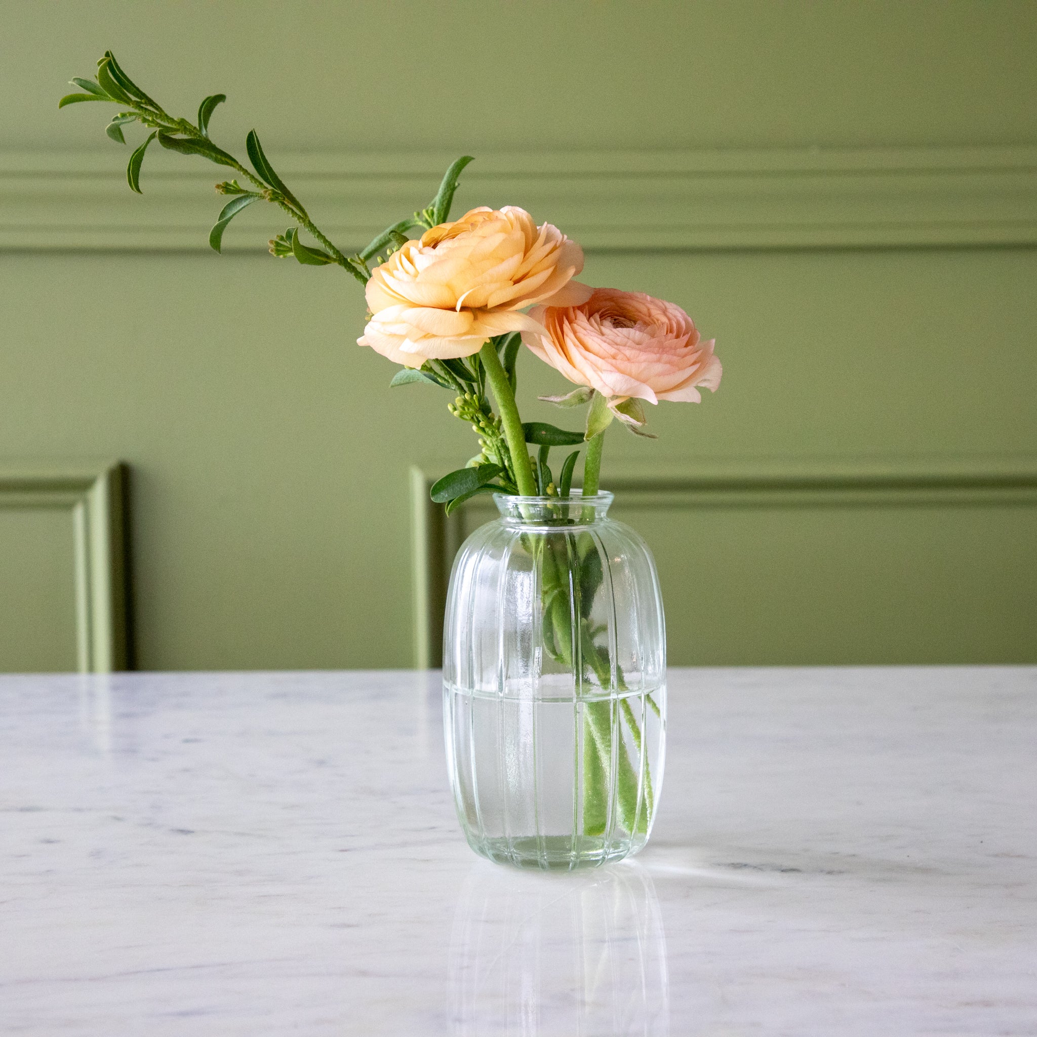 The Clear Glass Bud Vase with spring flowers in it.