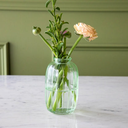 The Green Glass Bud Vase with spring flowers in it.