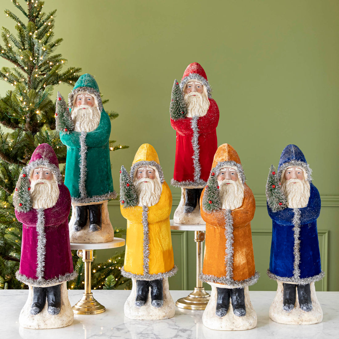 Six assorted 22&quot; Velvet Belsnickle figurines with a velvet robe adorned with tinsel trimming and glitter, holding a tree.