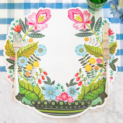 Die-cut Vase Arrangement Placemat with silverware on top.