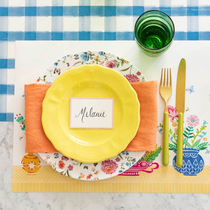 Vibrant Vases Placemat on the Blue Painted Check Runner, with a place setting on top.