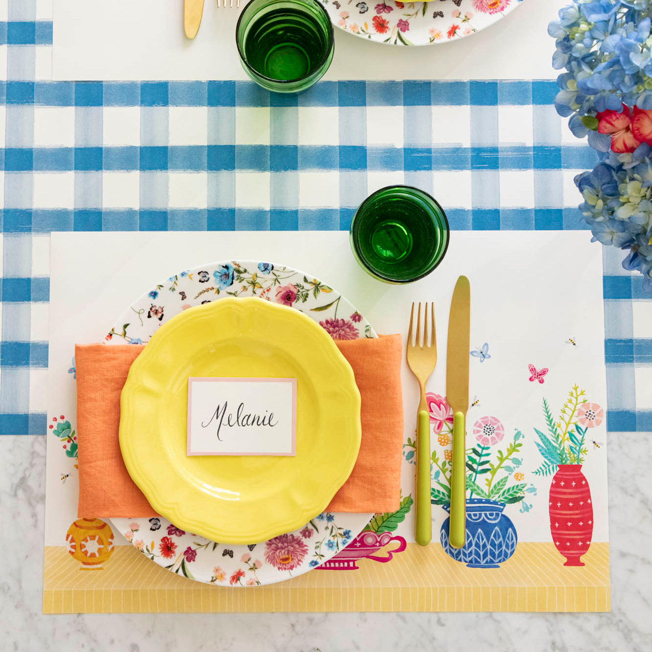 Vibrant Vases Placemat on the Blue Painted Check Runner, with a place setting on top.