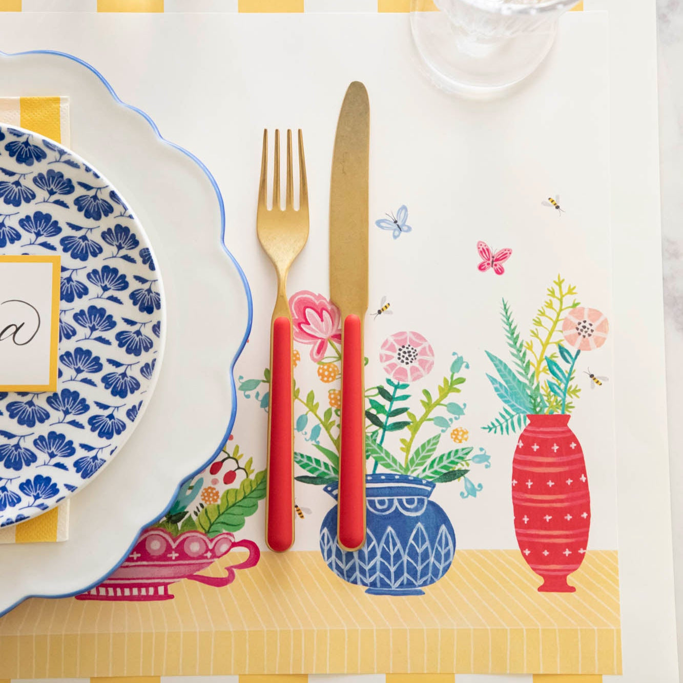 Close up of the Vibrant Vases Placemat with a place setting on top.