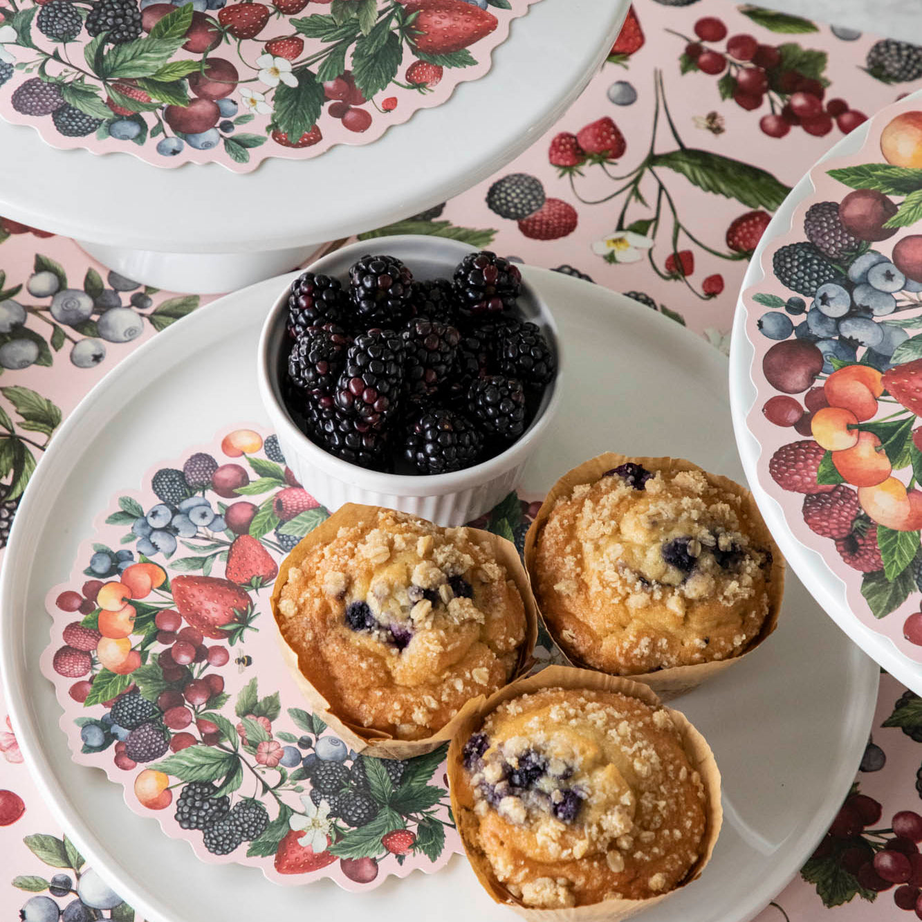 Wild Berry Serving Paper on a serving tray beneath a cup of blackberries and blueberry muffins.