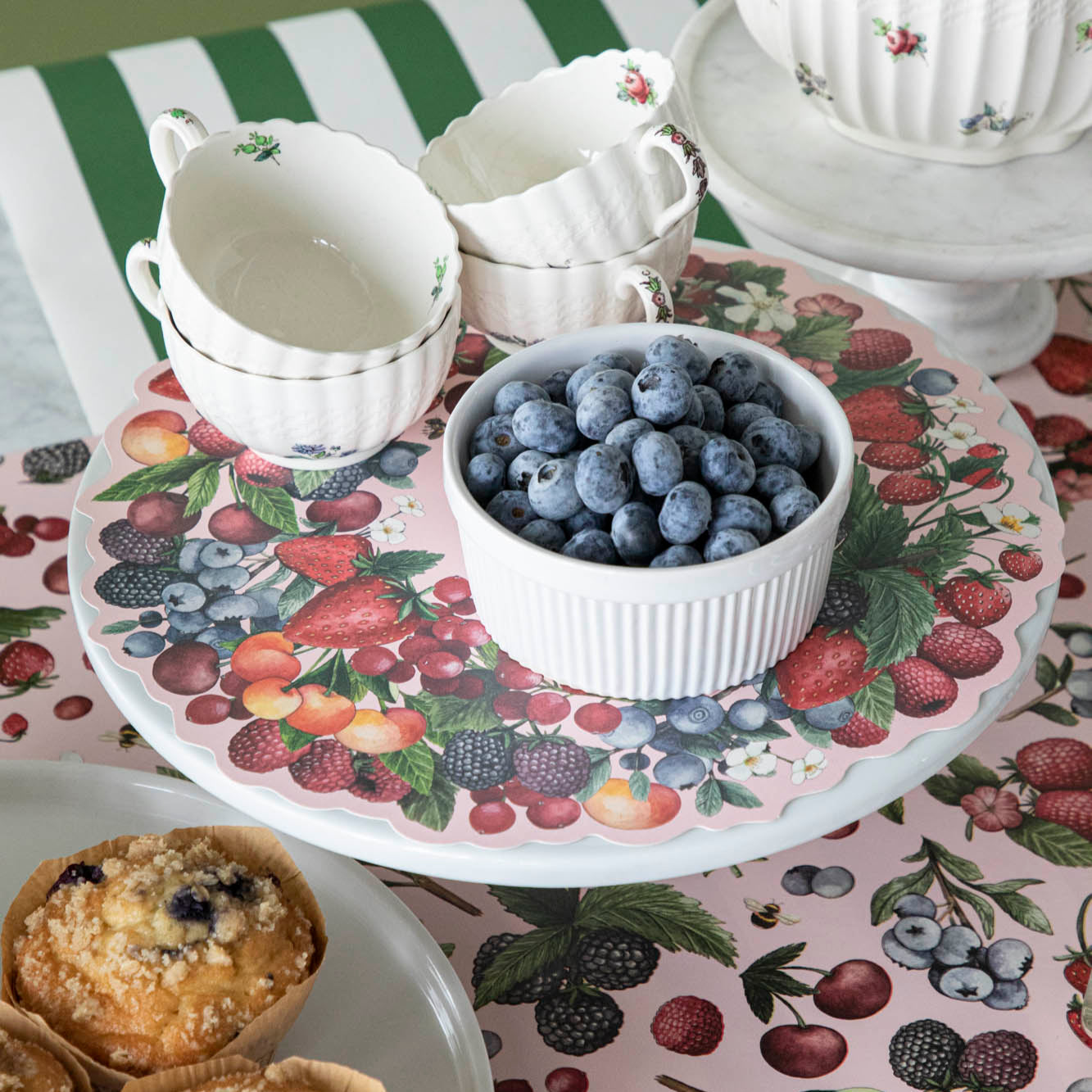 Wild Berry Serving Paper on a serving stand beneath a cup of blueberries and tea cups.