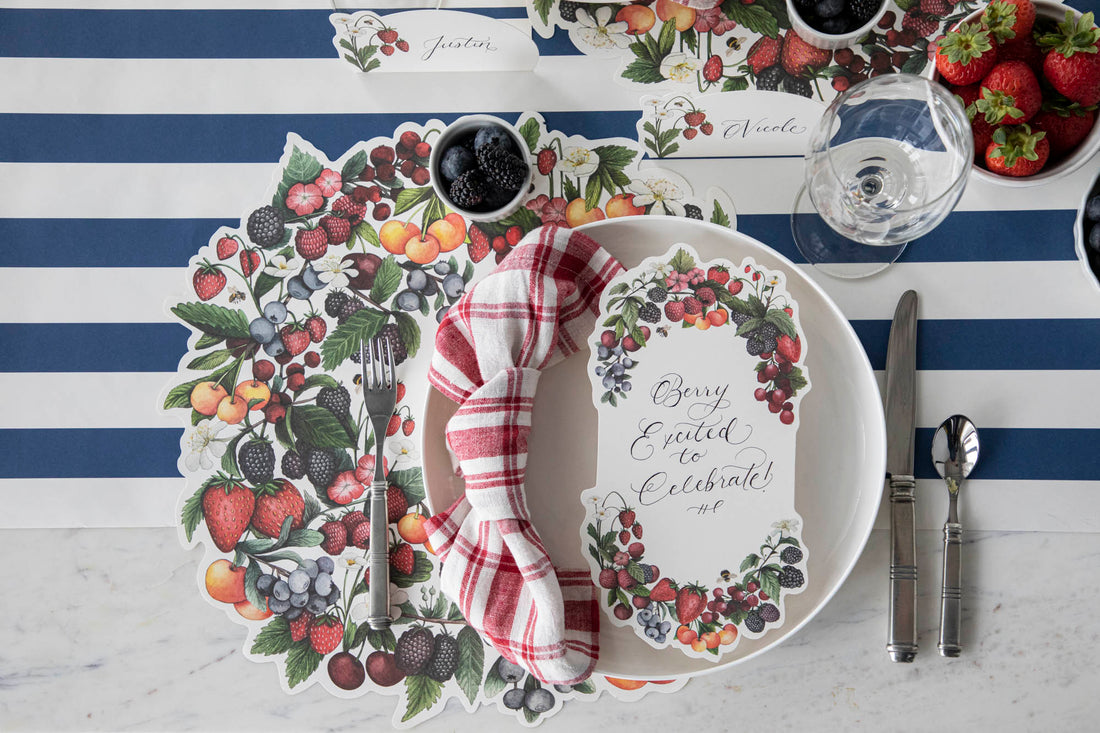 The Die-cut Berry Wreath Placemat under an elegant place setting, from above.