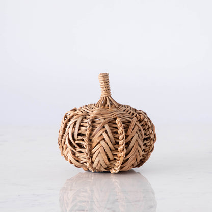 A small woven pumpkin on marble.