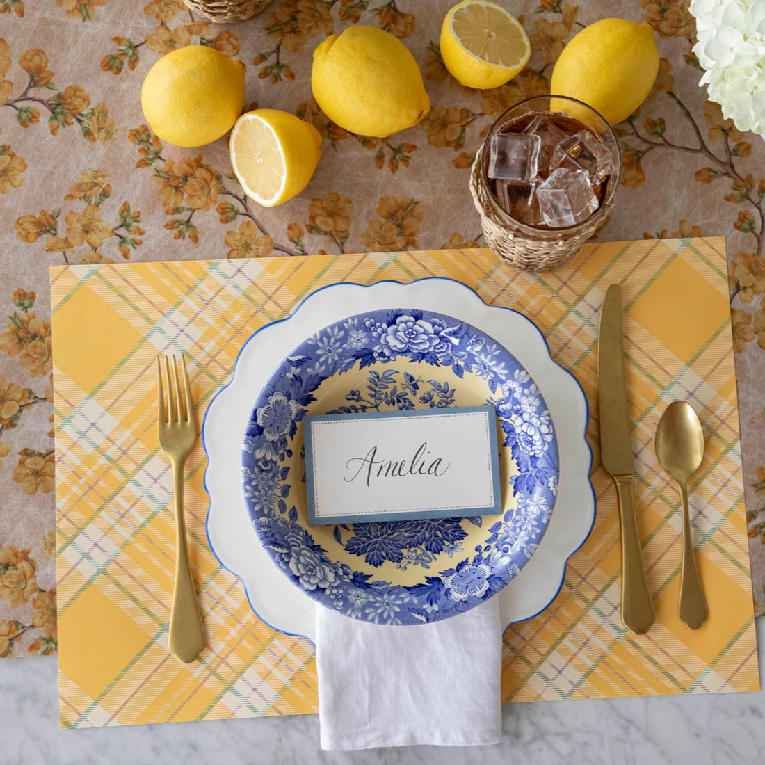 Yellow Plaid Placemat on the Marigold Cherry Blossom Runner, with a place setting for one on top.