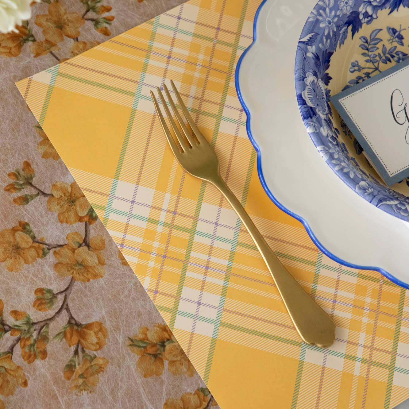 Yellow Plaid Placemat on the Marigold Cherry Blossom Runner, with a place setting for one on top.