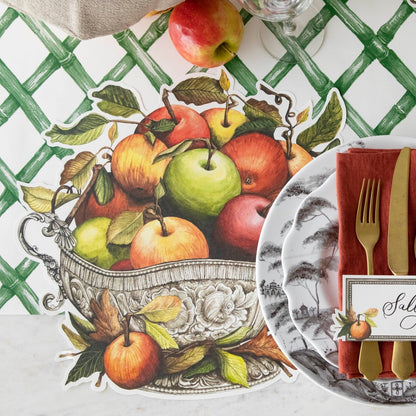 The Die-cut Apple Arrangement Placemat under an elegant place setting, from above.