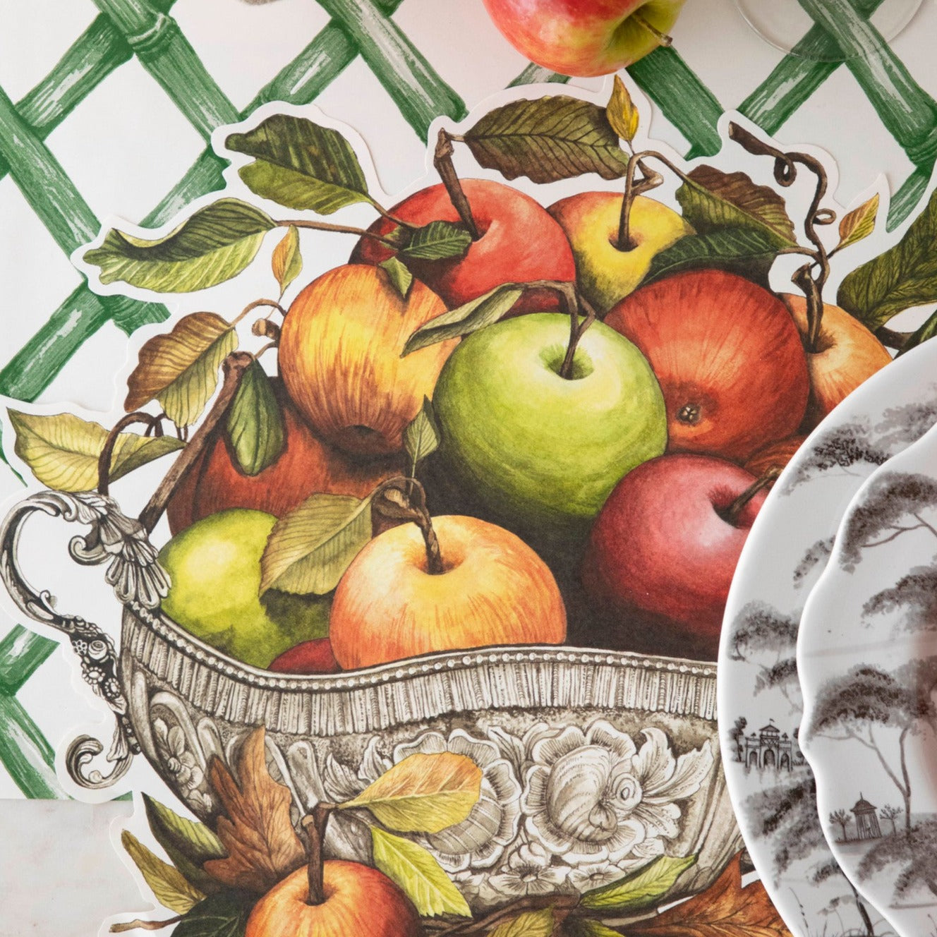 Close-up of the Die-cut Apple Arrangement Placemat under an elegant place setting, from above.