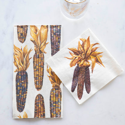 Two Maize Napkins, one Guest and one Cocktail, on a white table.