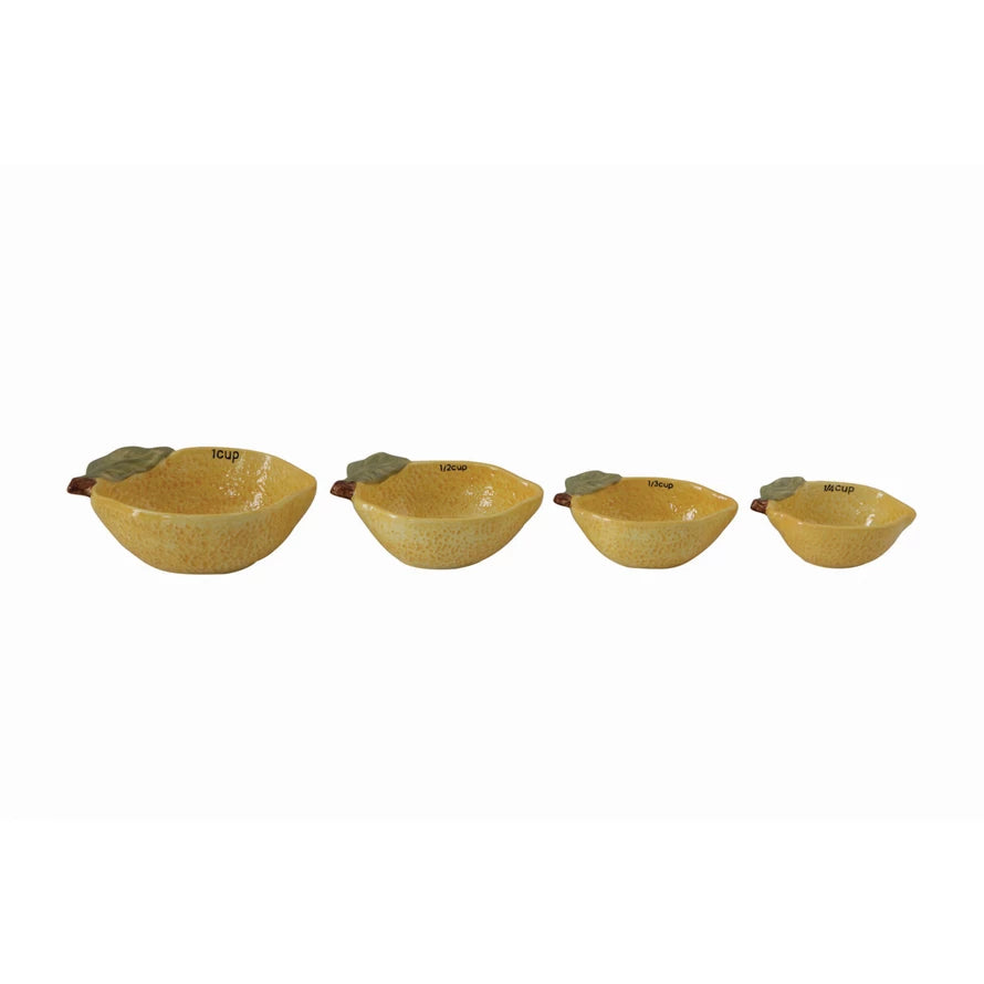 Stoneware Lemon Measuring Cups in a line, showing the measuring unit on the inside of each cup.