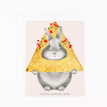 A Dear Hancock greetings card of a hand-drawn, graphite bunny peeking through a nacho with text that reads &quot;NACHO AVERAGE MOM&quot;.