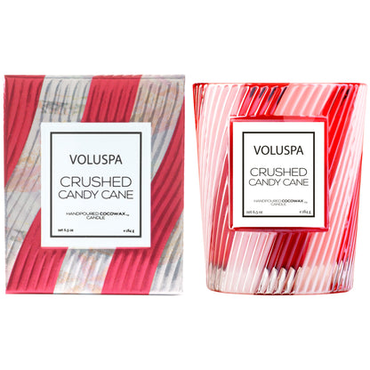 Red and white candy striped glass candle and corresponding box next to it.