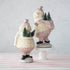 Two Sparkle Snowman figurines from Glitterville on top of a table spread holiday cheer.