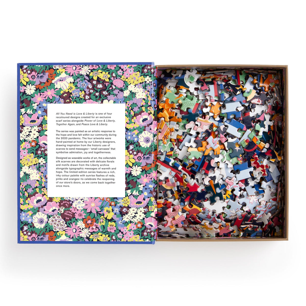 A jigsaw puzzle designed to look like a keepsake box with magnetic closure, titled &quot;Liberty All You Need is Love Puzzle&quot; featuring a colorful, Thorpe print design. It consists of the Liberty All You Need is Love 500 Piece Book Puzzle by Chronicle Books.