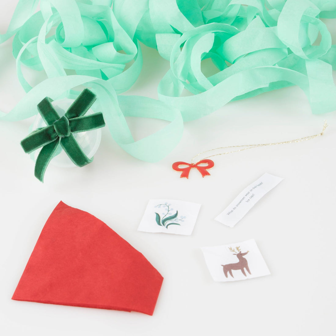 Our stylish surprise bows feature big red velvet bows and contain a red party hat, jokes, stickers and a bow enamel charm.