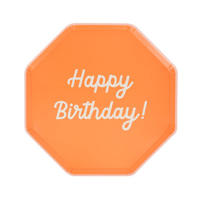 Octagonal shaped paper plate in orange saying &quot;Happy Birthday!&quot;. 