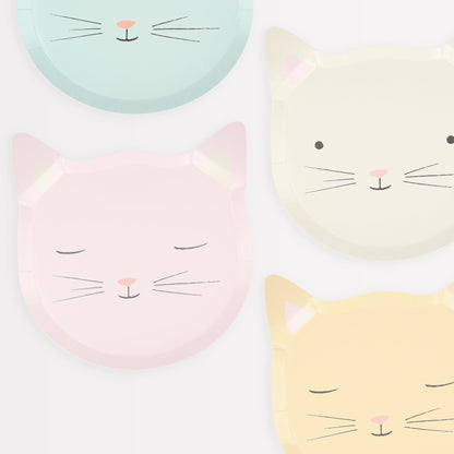 Four Meri Meri Cat Plates with cartoon cat faces in pastel colors, made from sustainable FSC paper.