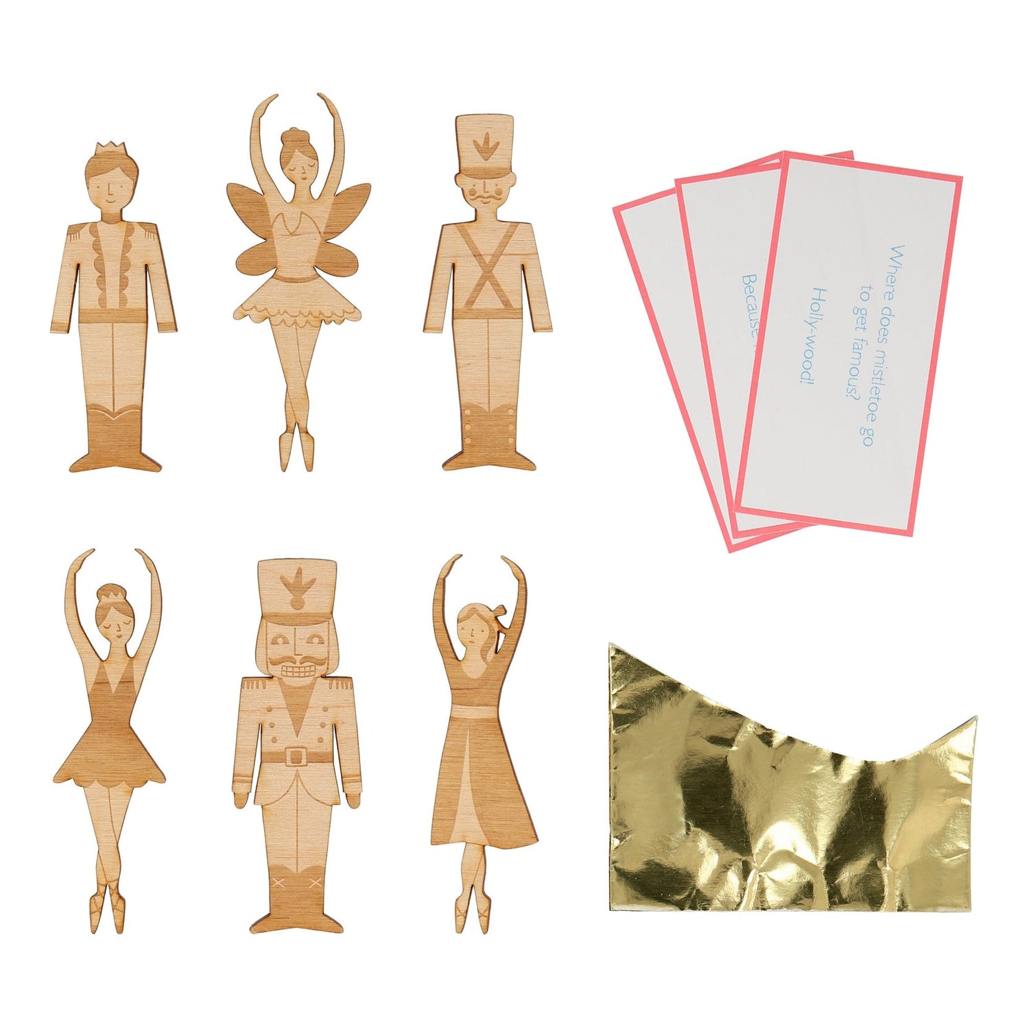 a gold foil paper hat, a joke, and an etched wooden Nutcracker character brooch, with a gold tone pin