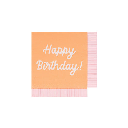 Orange Meri Meri napkin with Happy Birthday printed on it and coordinating fringe border. 