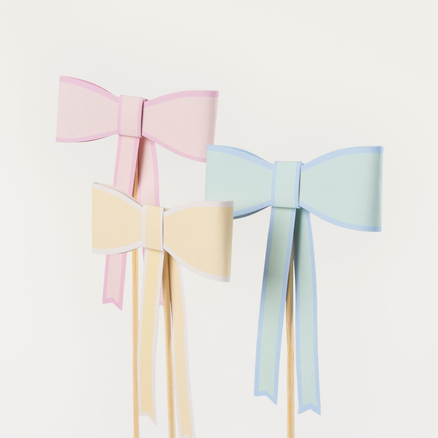 Mint, yellow and peach paper bow cake toppers. 