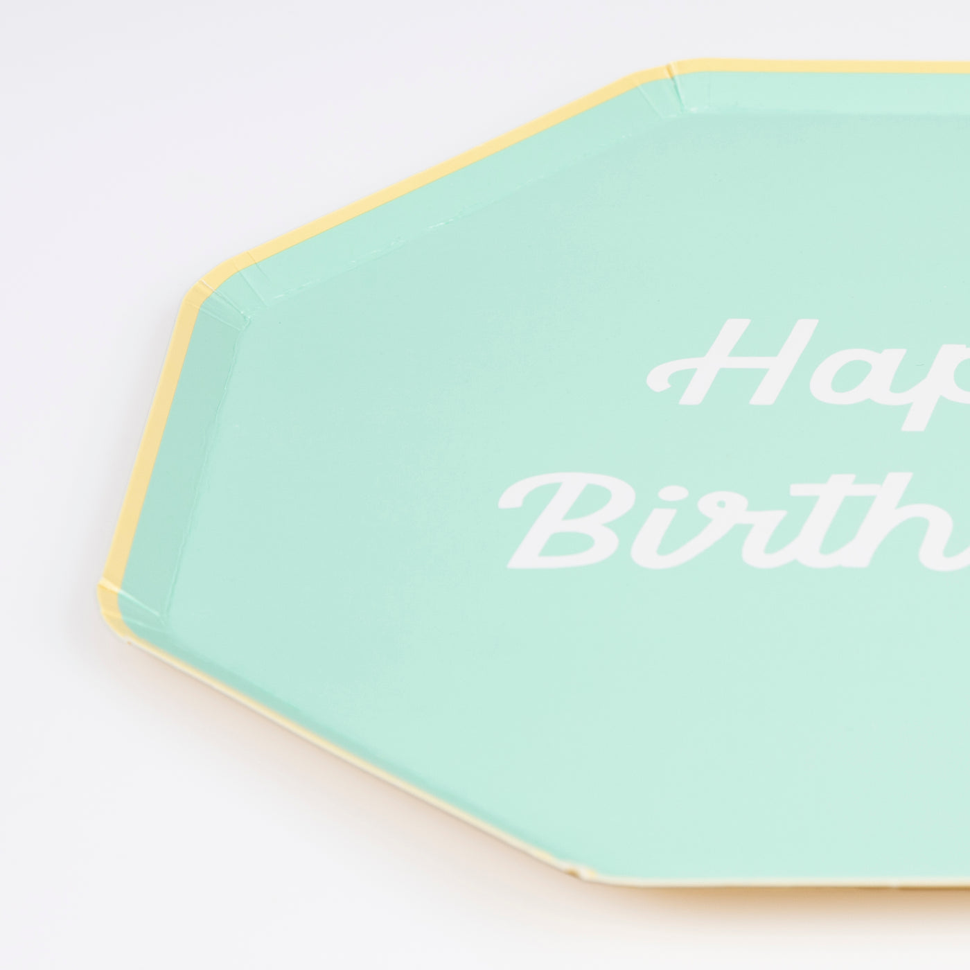 Octagonal shaped paper plate in mint saying &quot;Happy Birthday!&quot;. 