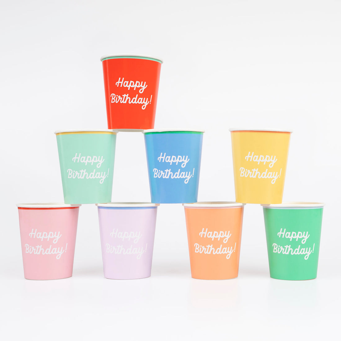 Meri Meri Happy Birthday Cups in a rainbow of colors printed with Happy Birthday on each.  