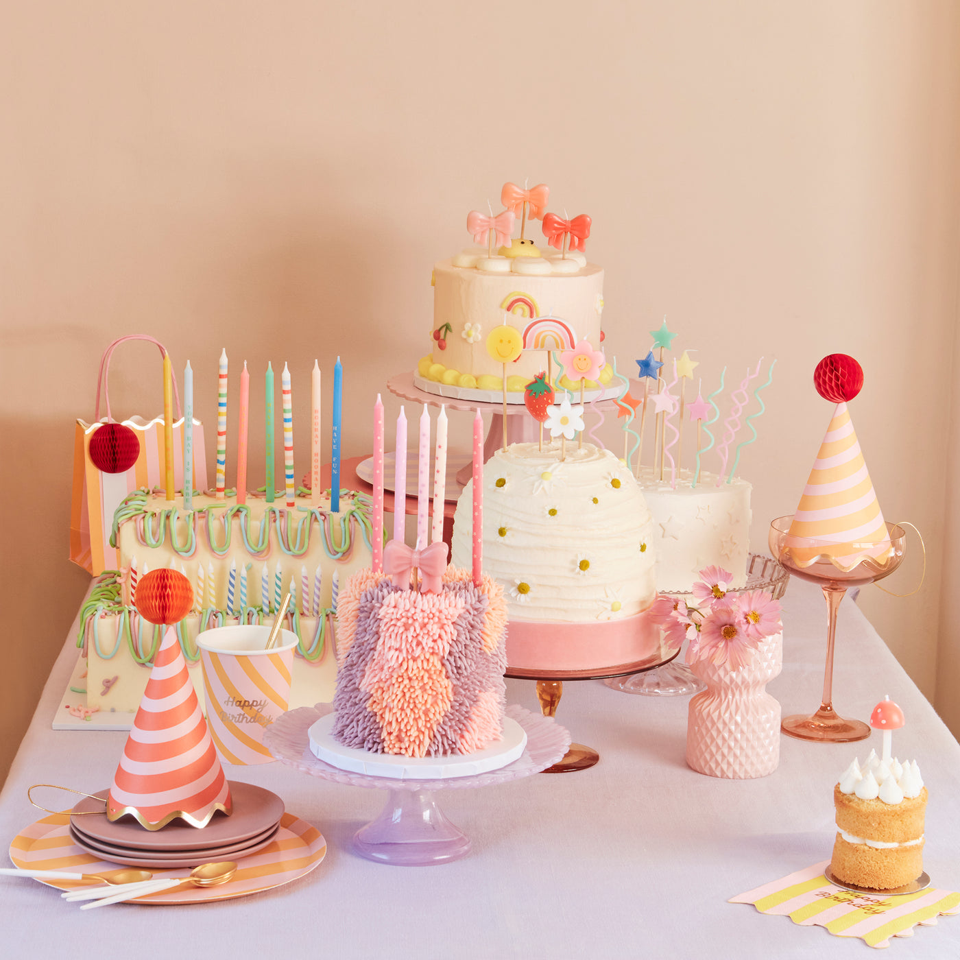 Birthday cakes with assorted candles on them. 