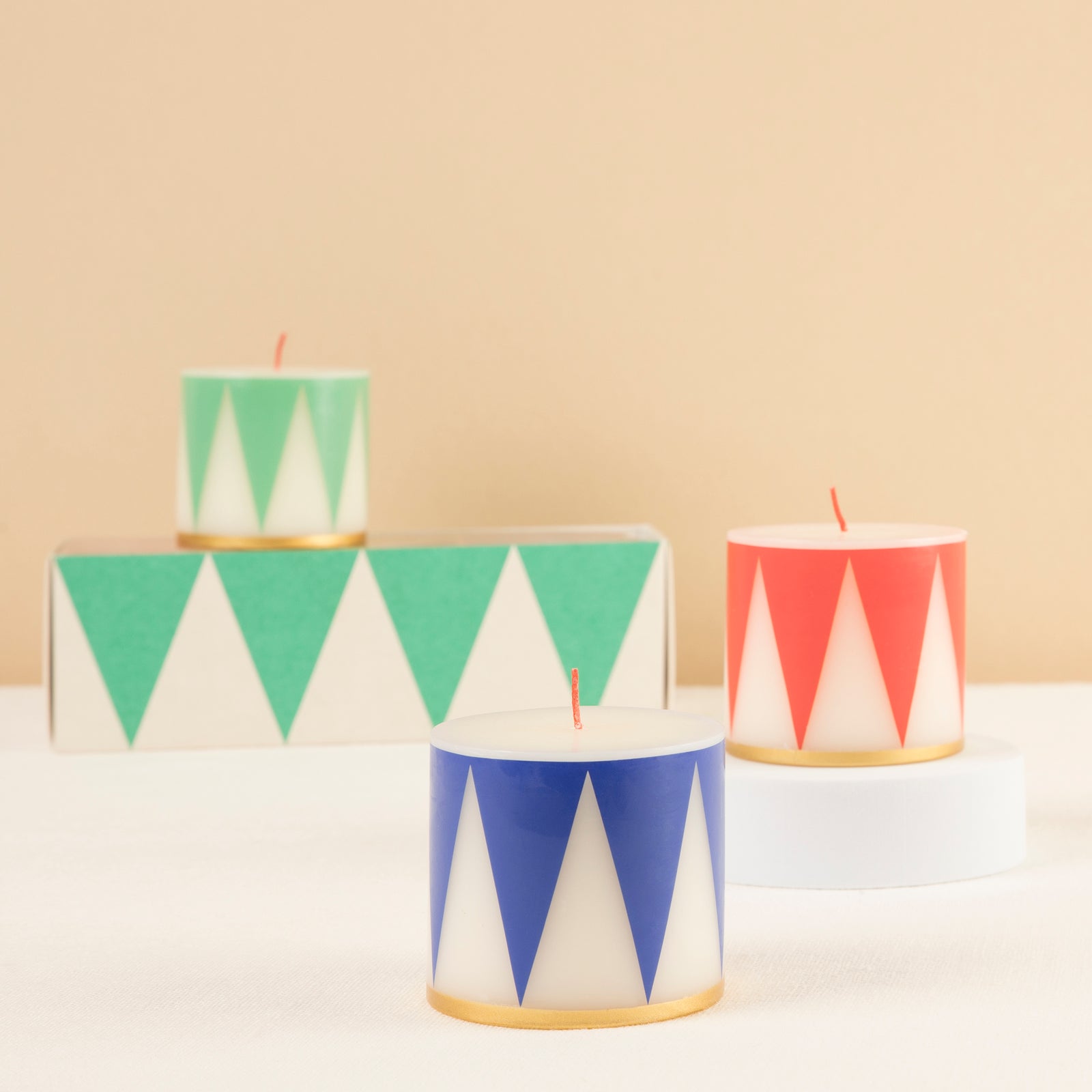 Drum Candle set of 3 candles have traditional Nutcracker designs of red, green and blue, with gold details and red wicks.
